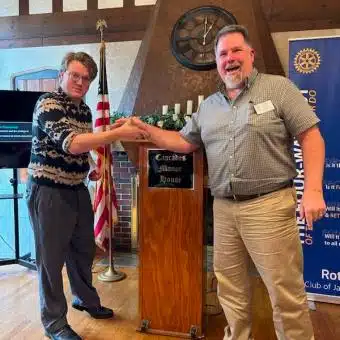Cascades Manor Rotary Club Meeting Two men shaking hands at Cascades Manor Rotary Club event.